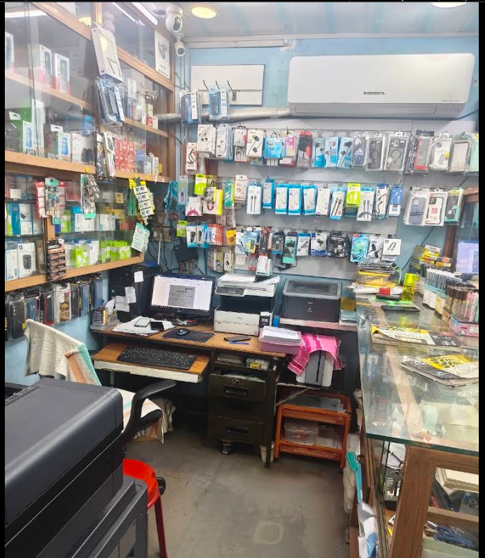 Interior of Jathin Media World with mobile accessories, computers and printers